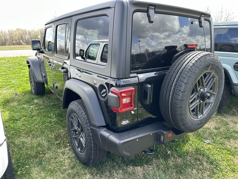 2024 Jeep Wrangler 4-door Sport S in a Black Clear Coat exterior color and Blackinterior. CDJR of Anytown 949-555-4321 pixelmotiondemo.com 