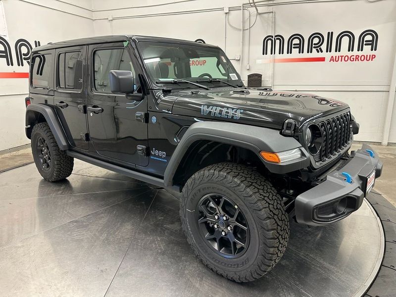 2024 Jeep Wrangler 4-door Willys 4xe in a Black Clear Coat exterior color and Blackinterior. Marina Auto Group (855) 564-8688 marinaautogroup.com 