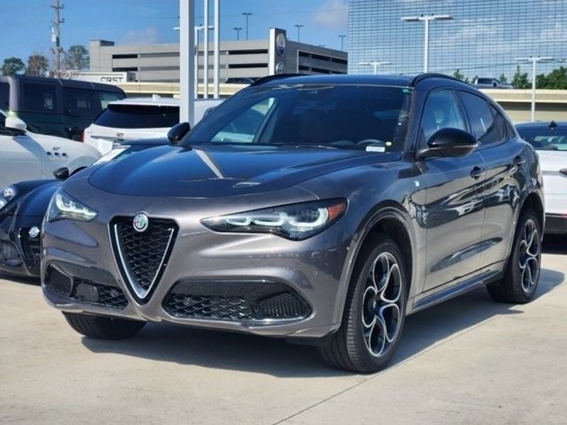 2024 Alfa Romeo Stelvio Ti in a Vesuvio Gray Metallic exterior color and Chocolateinterior. Northside Imports Houston 281-475-4549 northsideimportshouston.com 