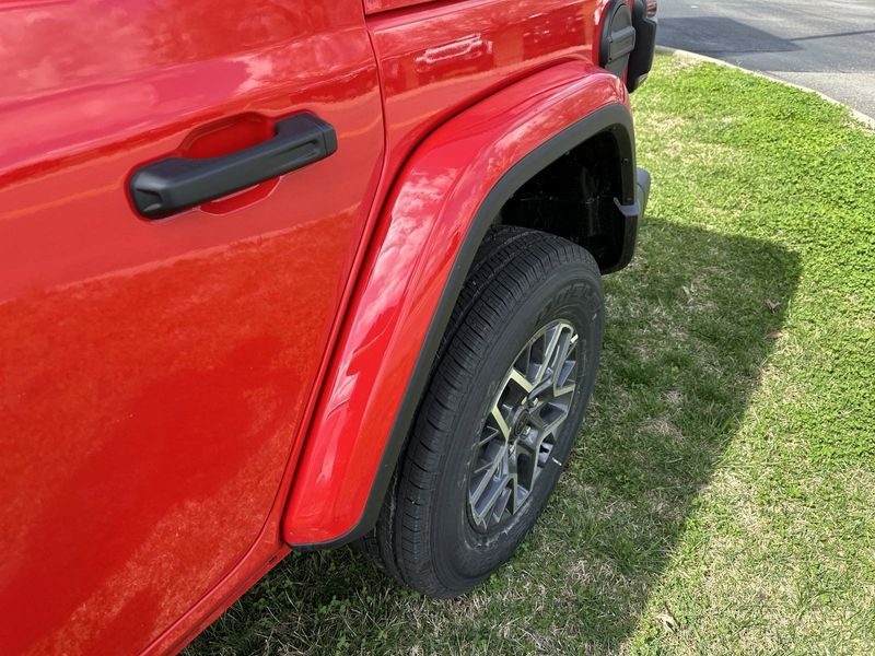 2024 Jeep Wrangler 4-door Sahara in a Firecracker Red Clear Coat exterior color. Gupton Motors Inc 615-384-2886 guptonmotors.com 