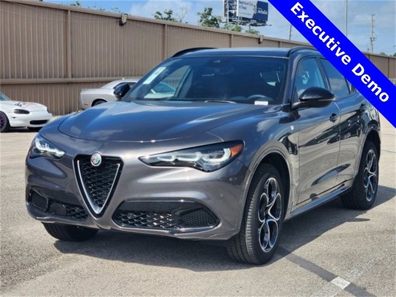 2024 Alfa Romeo Stelvio Ti Awd in a Vesuvio Gray Metallic exterior color and Chocolateinterior. Northside Alfa Romeo of Houston 281-475-4549 alfaromeousaofnorthhouston.com 