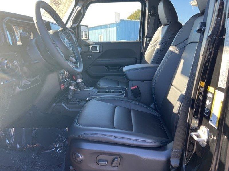 2024 Jeep Wrangler 4-door Rubicon X 4xe in a Black Clear Coat exterior color and Blackinterior. Lakeshore CDJR Seaford 302-213-6058 lakeshorecdjr.com 