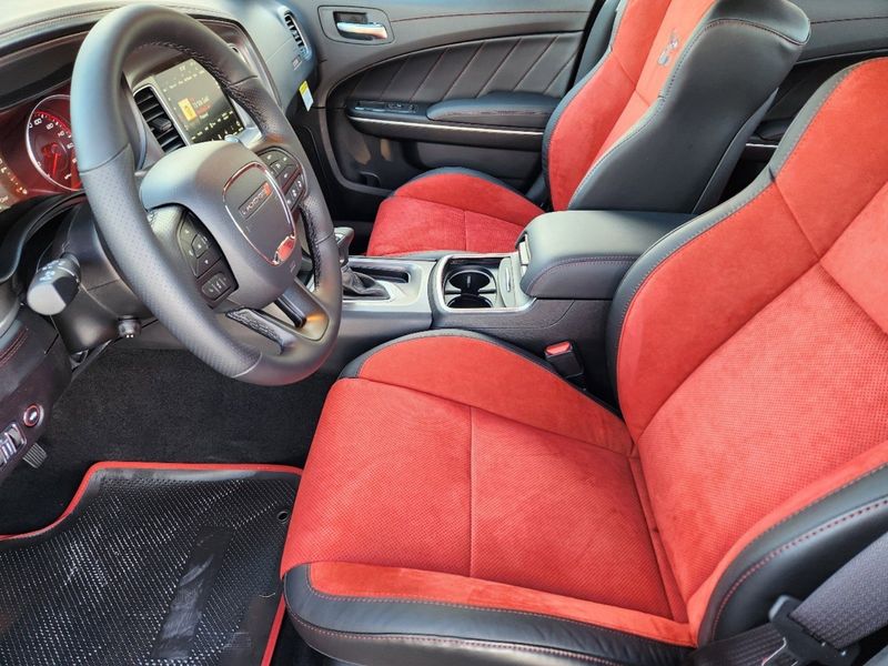 2023 Dodge Charger Scat Pack in a White Knuckle exterior color and Ruby Red/Blackinterior. Elder Chrysler Dodge Jeep Ram 9032920419 elderchryslerdodgejeep.com 