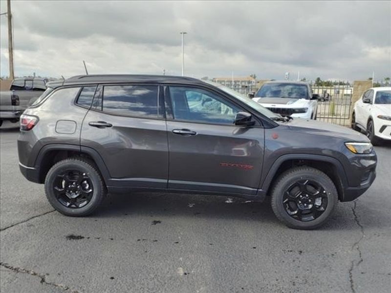 2024 Jeep Compass Trailhawk in a Granite Crystal Metallic Clear Coat exterior color and Ruby Red/Blackinterior. Perris Valley Auto Center 951-657-6100 perrisvalleyautocenter.com 