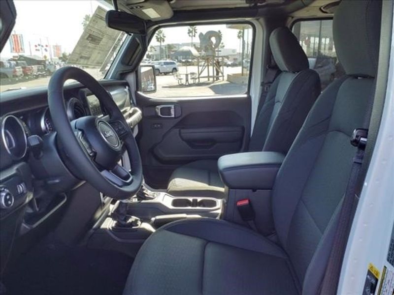 2023 Jeep Gladiator Sport in a Bright White Clear Coat exterior color and Blackinterior. Perris Valley Auto Center 951-657-6100 perrisvalleyautocenter.com 