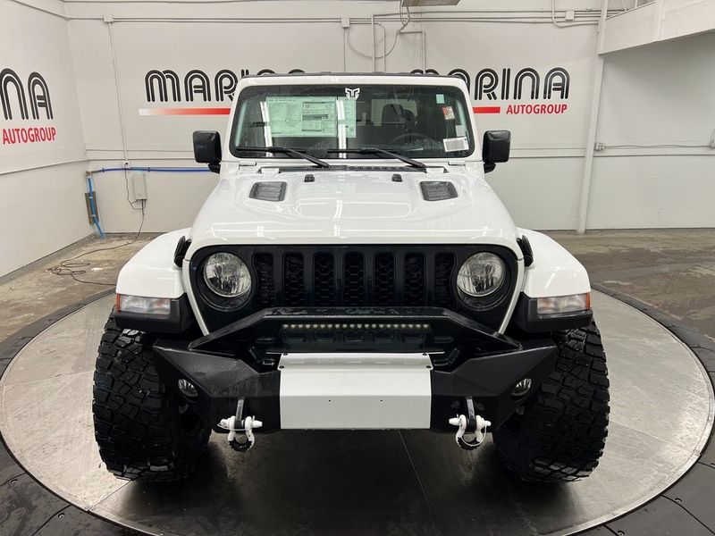 2022 Jeep Gladiator Sport S 4x4 in a Bright White Clear Coat exterior color and Global Black/Steel Grayinterior. Marina Chrysler Dodge Jeep RAM (855) 616-8084 marinadodgeny.com 