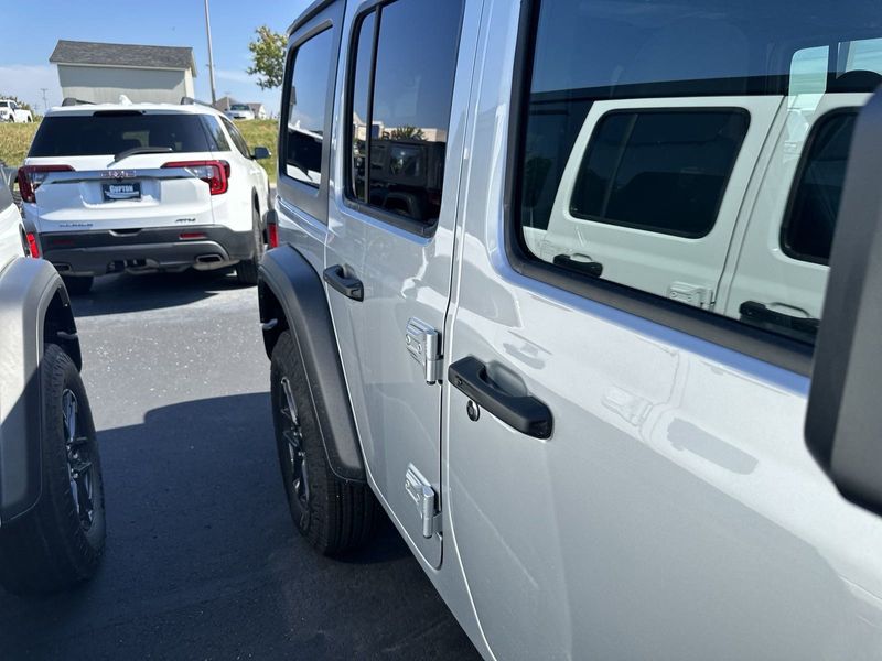 2024 Jeep Wrangler 4-door Sport S in a Silver Zynith Clear Coat exterior color and Blackinterior. CDJR of Anytown 949-555-4321 pixelmotiondemo.com 