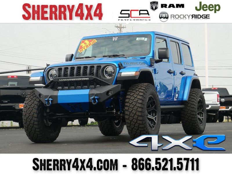 2023 Jeep Wrangler Rubicon 4xe in a Hydro Blue Pearl Coat exterior color and Black/Dark Saddleinterior. Paul Sherry Chrysler Dodge Jeep RAM (937) 749-7061 sherrychrysler.net 