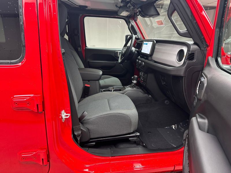2024 Jeep Wrangler 4-door Willys in a Firecracker Red Clear Coat exterior color and Blackinterior. Weekley Chrysler Dodge Jeep Co 419-740-1451 weekleychryslerdodgejeep.com 