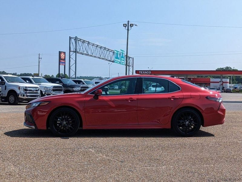 2023 Toyota Camry XSE in a Supersonic Red exterior color and Blackinterior. Johnson Dodge 601-693-6343 pixelmotiondemo.com 