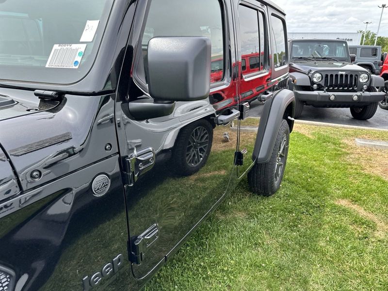 2024 Jeep Wrangler 4-door Sport S in a Black Clear Coat exterior color and Blackinterior. CDJR of Anytown 949-555-4321 pixelmotiondemo.com 