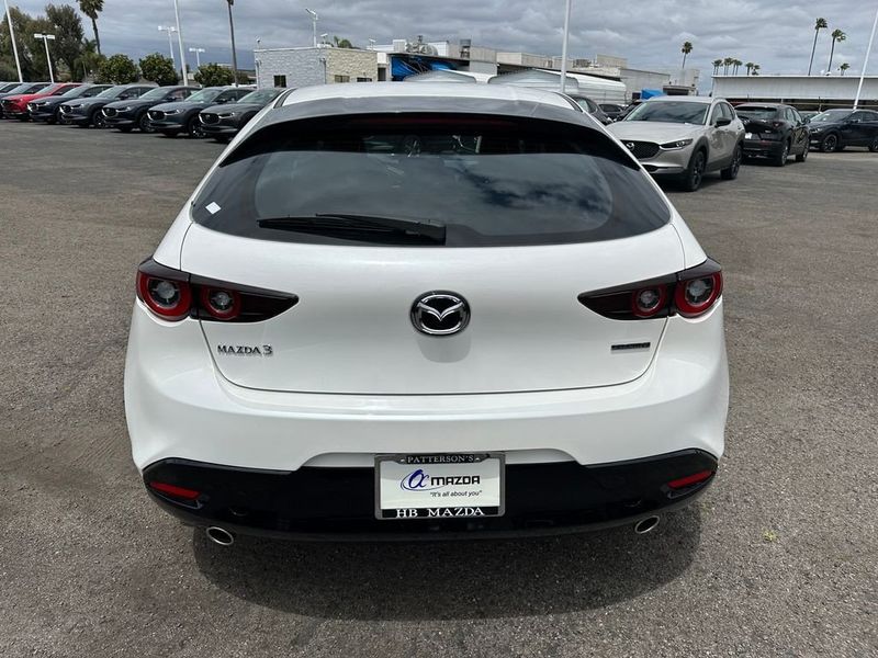 2024 Mazda Mazda3 2.5 S in a Snowflake White Pearl Mica exterior color and Blackinterior. BEACH BLVD OF CARS beachblvdofcars.com 