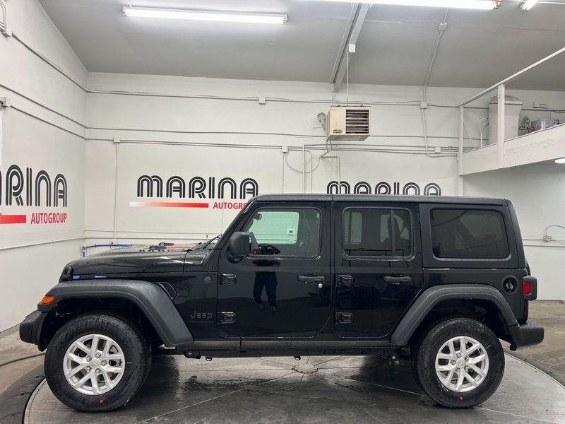 2023 Jeep Wrangler 4-door Sport S 4x4 in a Black Clear Coat exterior color and Blackinterior. Marina Auto Group (855) 564-8688 marinaautogroup.com 