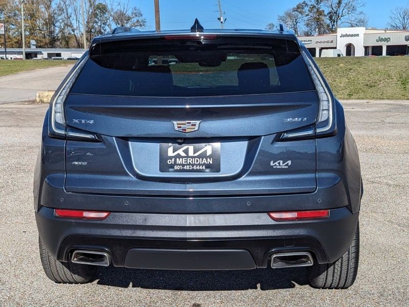 2021 Cadillac XT4 AWD Sport in a Shadow Metallic exterior color and Light Wheat/Jet Black w/Red Accentsinterior. Johnson Dodge 601-693-6343 pixelmotiondemo.com 