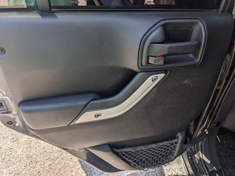 2017 Jeep Wrangler Unlimited Sahara in a Black Clear Coat exterior color and Blackinterior. Johnson Dodge 601-693-6343 pixelmotiondemo.com 