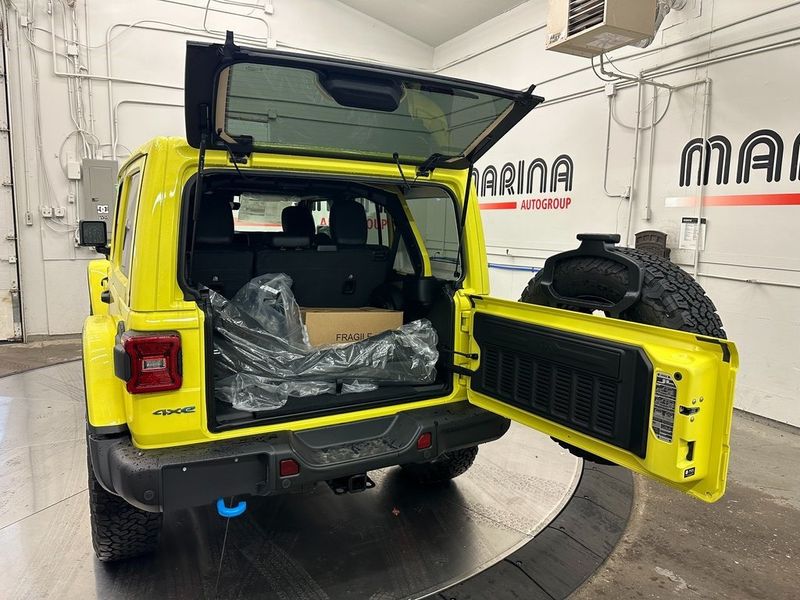 2024 Jeep Wrangler 4-door Rubicon X 4xe in a High Velocity Clear Coat exterior color and Blackinterior. Marina Auto Group (855) 564-8688 marinaautogroup.com 