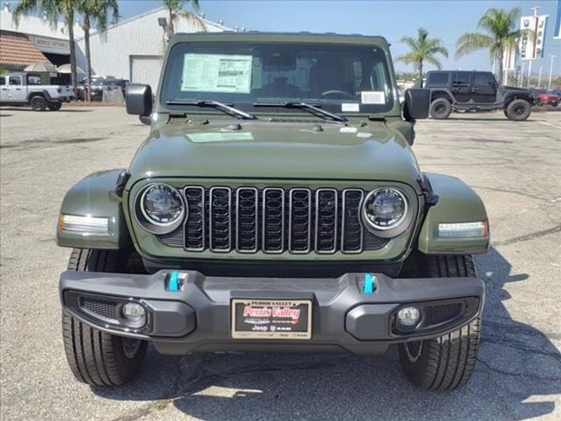 2024 Jeep Wrangler Sport S 4xe in a Sarge Green Clear Coat exterior color and Blackinterior. Perris Valley Auto Center 951-657-6100 perrisvalleyautocenter.com 