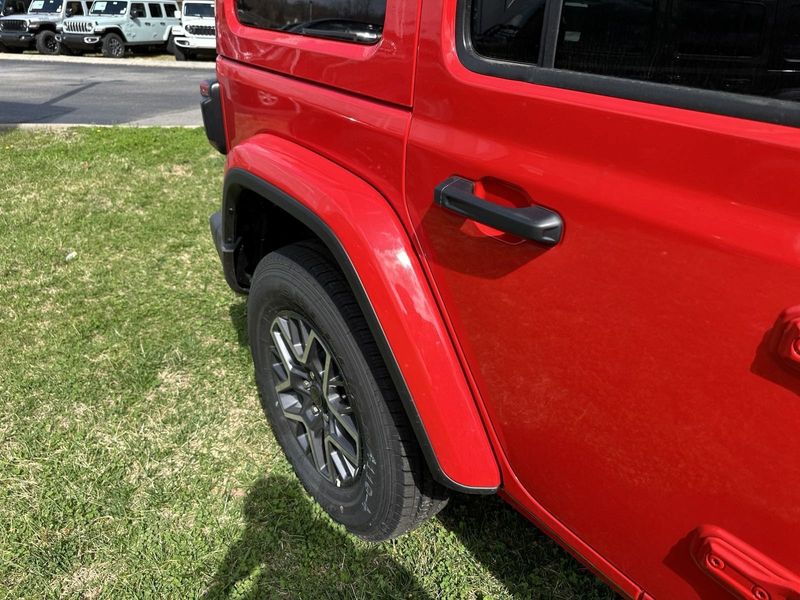 2024 Jeep Wrangler 4-door Sahara in a Firecracker Red Clear Coat exterior color. Gupton Motors Inc 615-384-2886 guptonmotors.com 