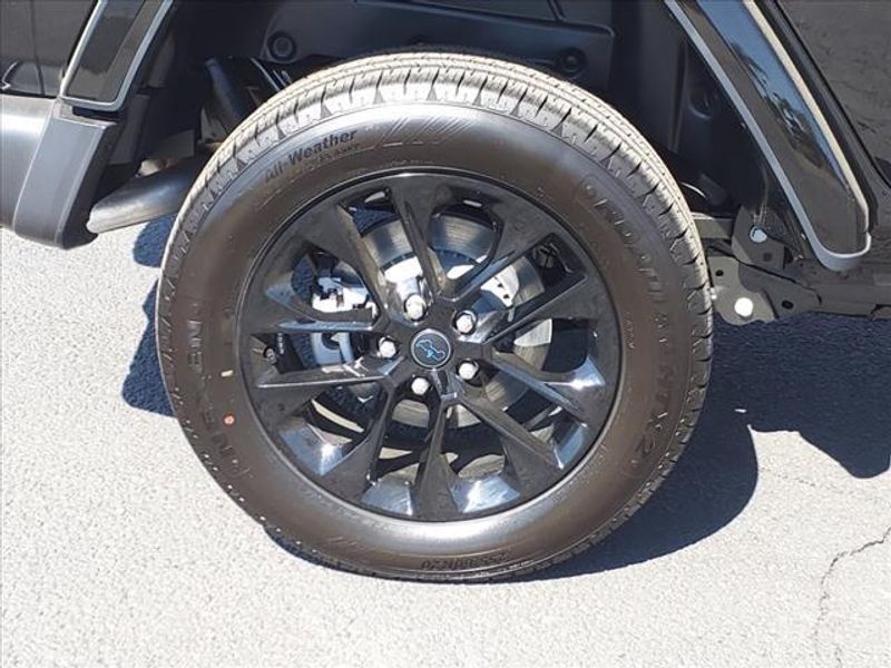 2024 Jeep Wrangler Sahara 4xe in a Black Clear Coat exterior color and Blackinterior. Perris Valley Auto Center 951-657-6100 perrisvalleyautocenter.com 