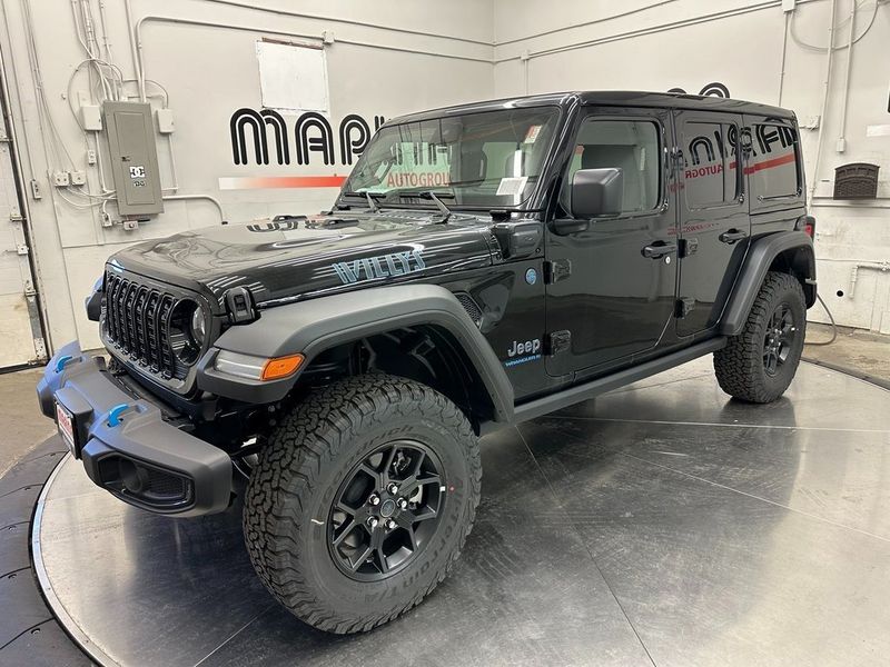 2024 Jeep Wrangler 4-door Willys 4xe in a Black Clear Coat exterior color and Blackinterior. Marina Auto Group (855) 564-8688 marinaautogroup.com 