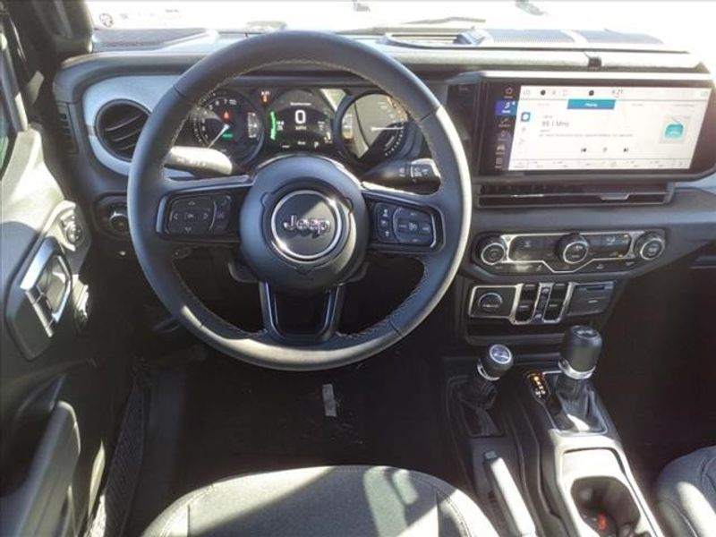 2024 Jeep Wrangler Sport S 4xe in a Black Clear Coat exterior color and Blackinterior. Perris Valley Auto Center 951-657-6100 perrisvalleyautocenter.com 