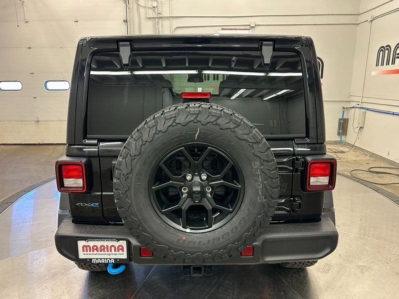 2024 Jeep Wrangler 4-door Willys 4xe in a Black Clear Coat exterior color and Blackinterior. Marina Auto Group (855) 564-8688 marinaautogroup.com 