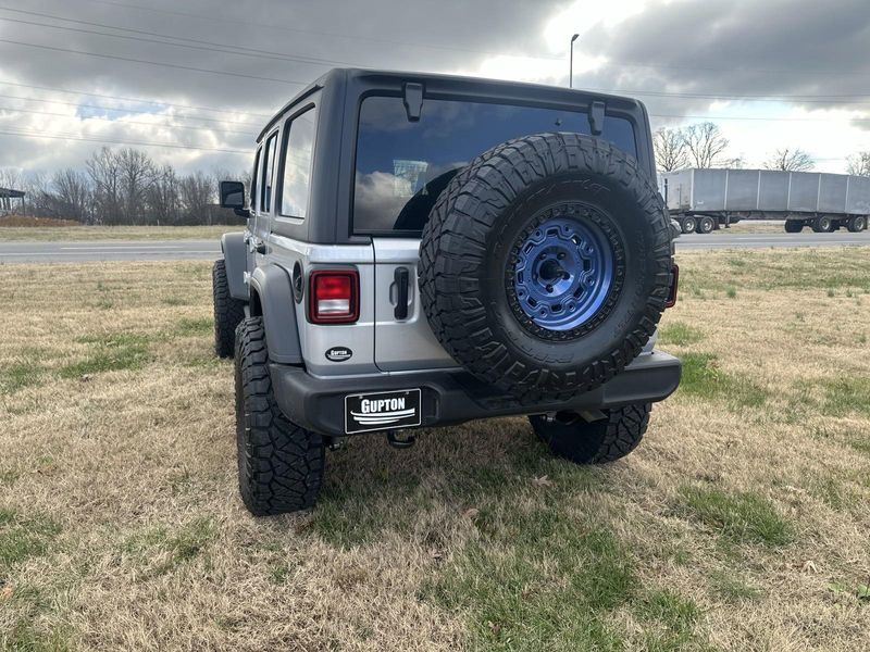 2024 Jeep Wrangler 4-door Sport S in a Silver Zynith Clear Coat exterior color and Blackinterior. Gupton Motors Inc 615-384-2886 guptonmotors.com 