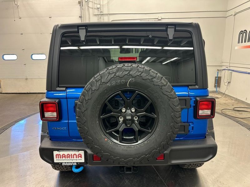 2024 Jeep Wrangler 4-door Willys 4xe in a Hydro Blue Pearl Coat exterior color and Blackinterior. Marina Chrysler Dodge Jeep RAM (855) 616-8084 marinadodgeny.com 