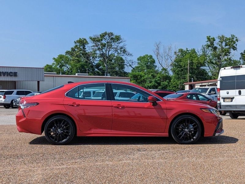 2023 Toyota Camry XSE in a Supersonic Red exterior color and Blackinterior. Johnson Dodge 601-693-6343 pixelmotiondemo.com 