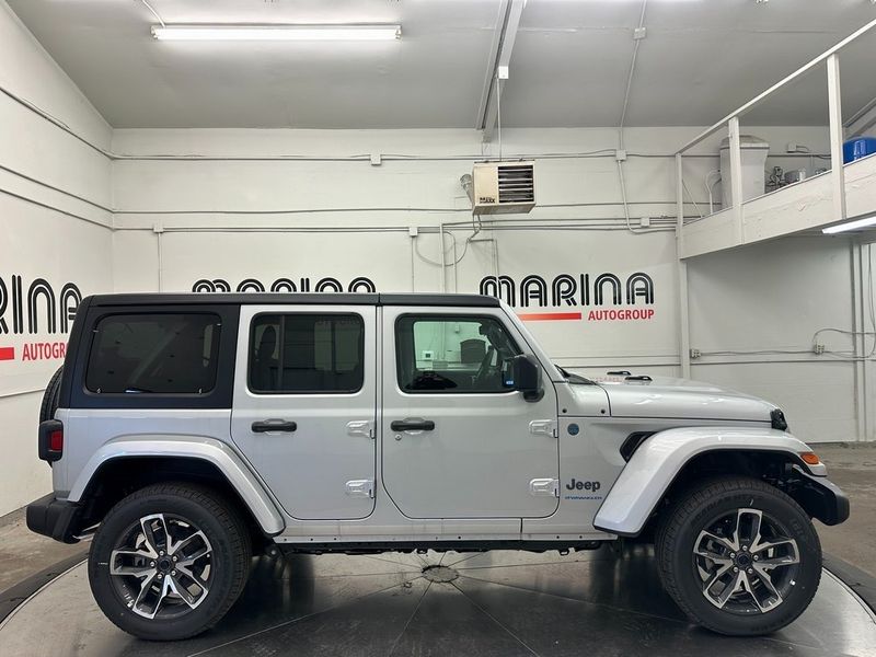 2024 Jeep Wrangler 4-door Sport S 4xe in a Silver Zynith Clear Coat exterior color and Blackinterior. Marina Chrysler Dodge Jeep RAM (855) 616-8084 marinadodgeny.com 