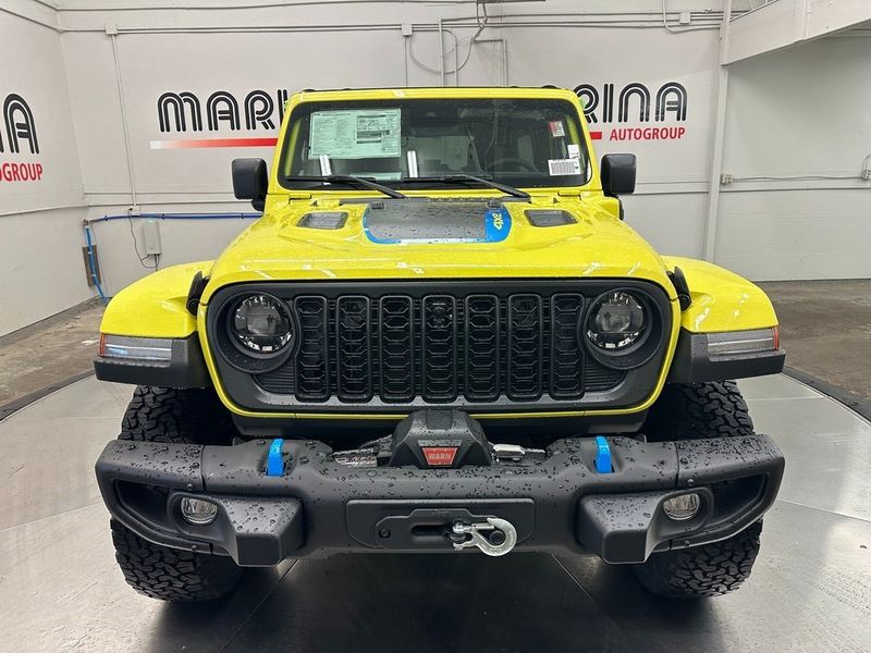 2024 Jeep Wrangler 4-door Rubicon X 4xe in a High Velocity Clear Coat exterior color and Blackinterior. Marina Chrysler Dodge Jeep RAM (855) 616-8084 marinadodgeny.com 