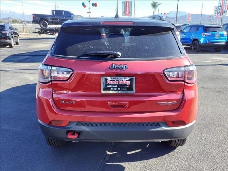 2024 Jeep Compass Trailhawk in a Prm exterior color and Ruby Red/Blackinterior. Perris Valley Auto Center 951-657-6100 perrisvalleyautocenter.com 