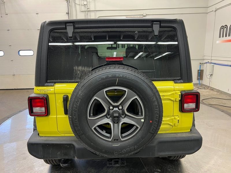 2023 Jeep Wrangler 4-door Sport S 4x4 in a High Velocity Clear Coat exterior color and Blackinterior. Marina Chrysler Dodge Jeep RAM (855) 616-8084 marinadodgeny.com 