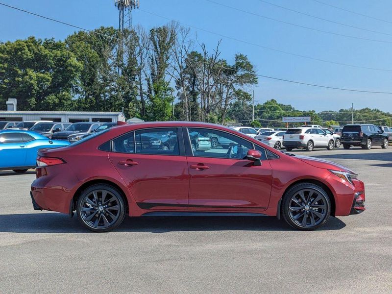 2023 Toyota Corolla SE in a Ruby Flare Pearl exterior color and Black/Redinterior. Johnson Dodge 601-693-6343 pixelmotiondemo.com 