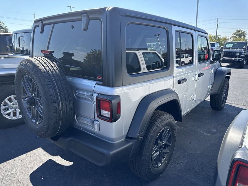 2024 Jeep Wrangler 4-door Sport S in a Silver Zynith Clear Coat exterior color and Blackinterior. CDJR of Anytown 949-555-4321 pixelmotiondemo.com 