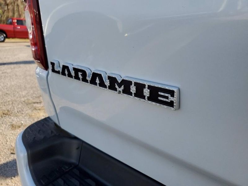 2019 RAM 1500 Laramie in a Ivory White Tri Coat Pearl Coat exterior color and Blackinterior. Johnson Dodge 601-693-6343 pixelmotiondemo.com 
