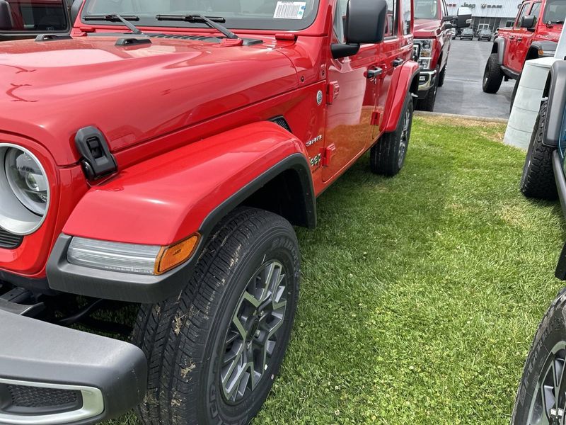 2024 Jeep Wrangler 4-door Sahara in a Firecracker Red Clear Coat exterior color. Gupton Motors Inc 615-384-2886 guptonmotors.com 