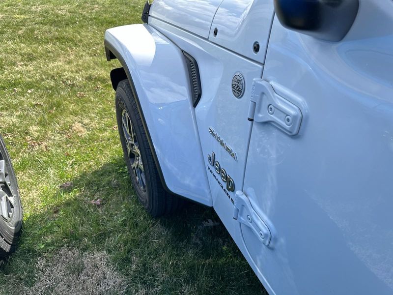 2024 Jeep Wrangler 4-door Sahara in a Bright White Clear Coat exterior color. Gupton Motors Inc 615-384-2886 guptonmotors.com 