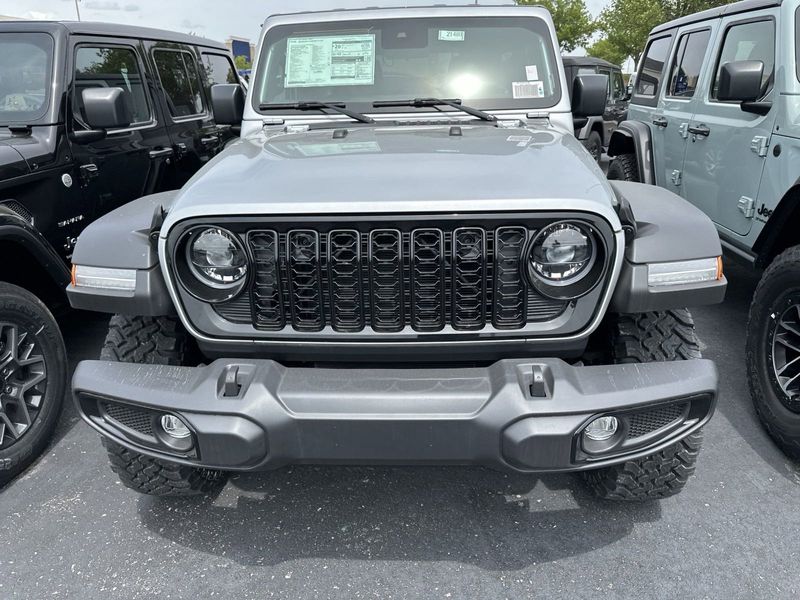 2024 Jeep Wrangler 4-door Willys in a Silver Zynith Clear Coat exterior color and Blackinterior. CDJR of Anytown 949-555-4321 pixelmotiondemo.com 