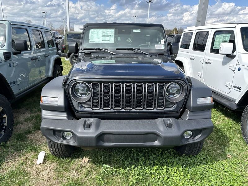 2024 Jeep Wrangler 4-door Sport S in a Black Clear Coat exterior color and Blackinterior. CDJR of Anytown 949-555-4321 pixelmotiondemo.com 