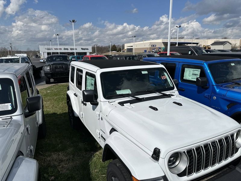 2024 Jeep Wrangler 4-door Sahara in a Bright White Clear Coat exterior color. Gupton Motors Inc 615-384-2886 guptonmotors.com 