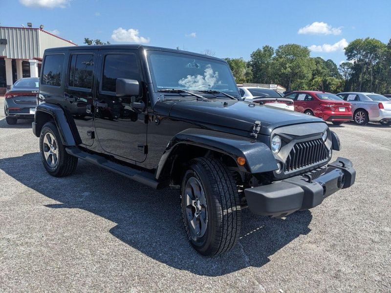 2017 Jeep Wrangler Unlimited Sahara in a Black Clear Coat exterior color and Blackinterior. Johnson Dodge 601-693-6343 pixelmotiondemo.com 