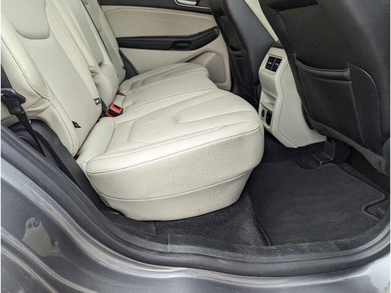 2022 Ford Edge Titanium in a Carbonized Gray Metallic exterior color and Medium Soft Ceramicinterior. Johnson Dodge 601-693-6343 pixelmotiondemo.com 