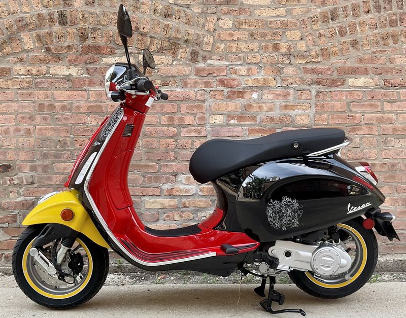 2023 Vespa Primavera 50 Disney Mickey Mouse Edition in a Black Red Yellow Mickey Mouse Collab exterior color. Motoworks Chicago 312-738-4269 motoworkschicago.com 