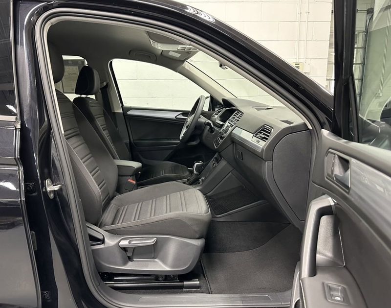 2023 Volkswagen Tiguan S / Driver Asst Pkg in a Deep Black Pearl exterior color and Black Heated Seatsinterior. Schmelz Countryside Alfa Romeo (651) 867-3222 schmelzalfaromeo.com 