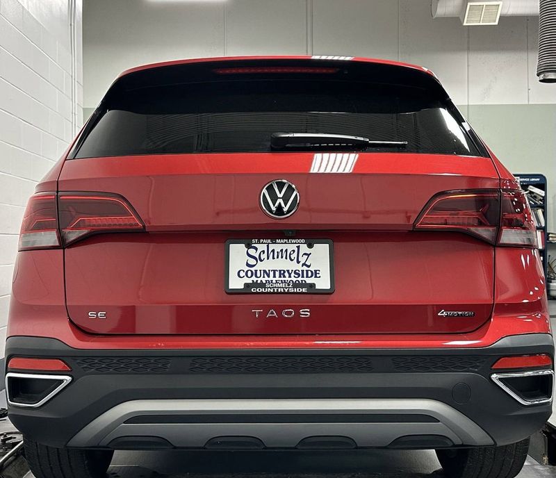 2023 Volkswagen Taos SE 4-Motion AWD w/Black Wheel Pkg in a Kings Red Metallic exterior color and Black heated seatsinterior. Schmelz Countryside SAAB (888) 558-1064 stpaulsaab.com 