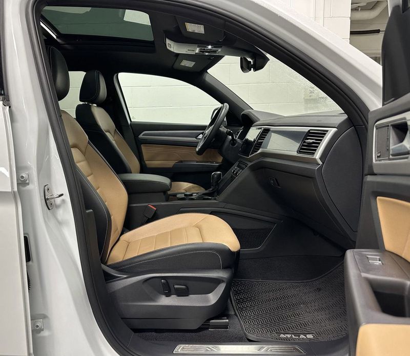 2023 Volkswagen Atlas Cross Sport SEL Premium R-Line AWD w/Sunroof & Navi in a Opal White Pearl exterior color and Cinnamon Brown Heated & Vented Leatherinterior. Schmelz Countryside SAAB (888) 558-1064 stpaulsaab.com 